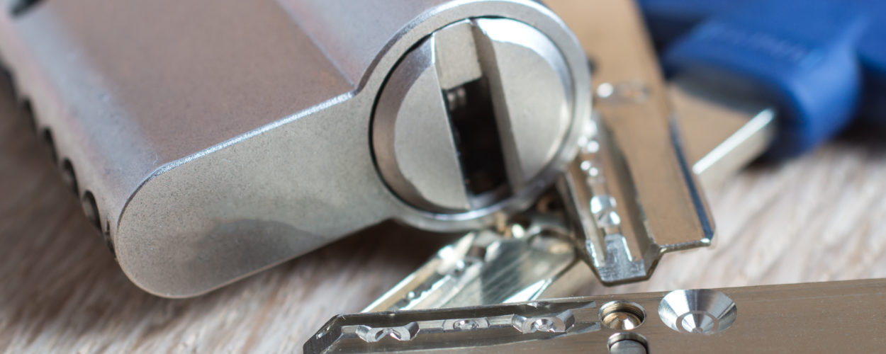 door lock with keys on wooden surface, close up